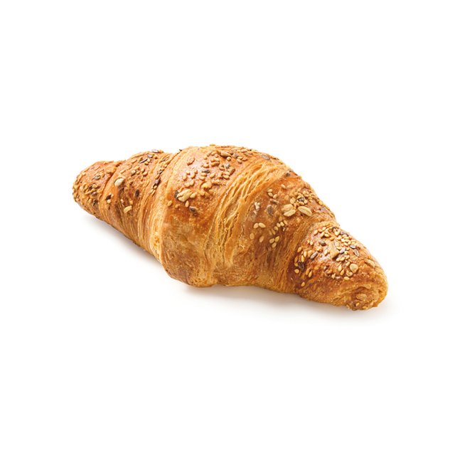 Croissant multicereal dorado, cubierto con semillas y avena, sobre fondo blanco.