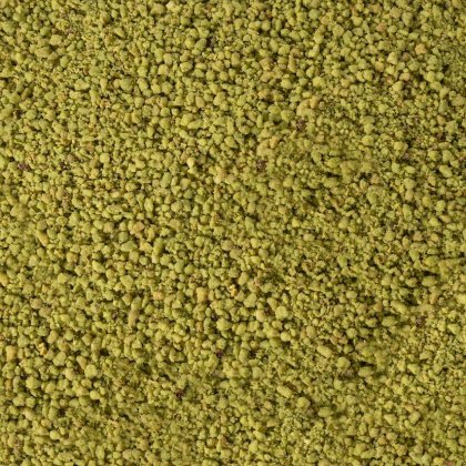 Primer plano de una textura de polvo amarillo verdoso, granulada y gruesa, que cubre todo el encuadre.